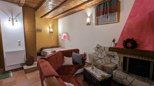 a living room with a couch and a fireplace at Diminio 3 Apartment at Livadi Arachova in Arachova