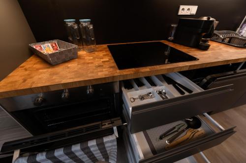 a kitchen counter with a sink and a stove at Mlýn Herlíkovice in Hořejší Vrchlabí