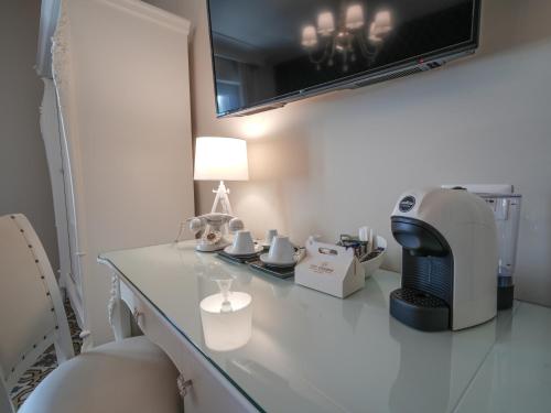 a room with a table with a sewing machine on it at Sui Generis Tropea Luxury Rooms in Tropea