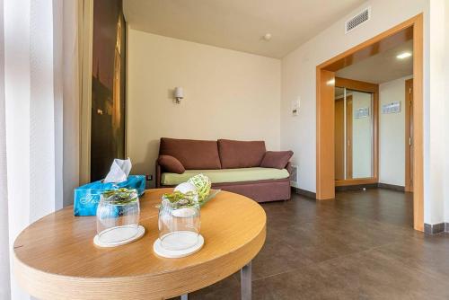 a living room with a table and a couch at Hotel Pere III El Gran in Vilafranca del Penedès