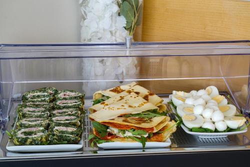 a refrigerator filled with sandwiches and other food items at Sui Generis Tropea Luxury Rooms in Tropea