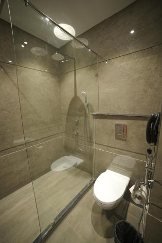 a bathroom with a shower and a toilet at ANTILIA BY ZION in Sonīpat