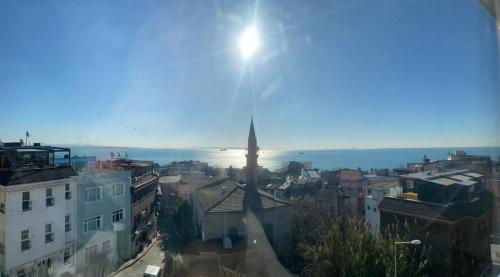 a view of a city with the sun in the sky at Timeks Suite Sultanahmet in Istanbul