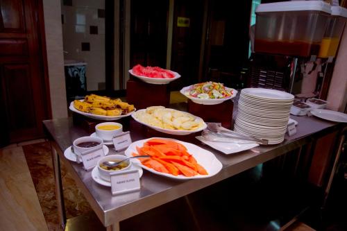 a buffet with bowls of food on a table at Tiffany Diamond Hotels LTD - Makunganya in Dar es Salaam