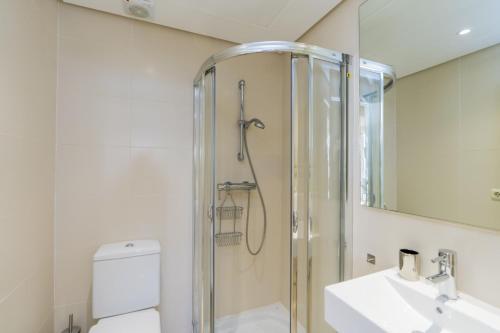 a bathroom with a shower and a toilet and a sink at Al-411 Estepona - Apartment - Alcazaba Lagoon in Estepona
