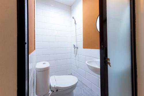 a bathroom with a toilet and a sink at RedDoorz near Mangga Dua Mall in Jakarta