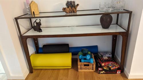 a shelf with a yellow ottoman in a room at Luxury, Spacious, Sunny home in the heart of Berlin in Berlin