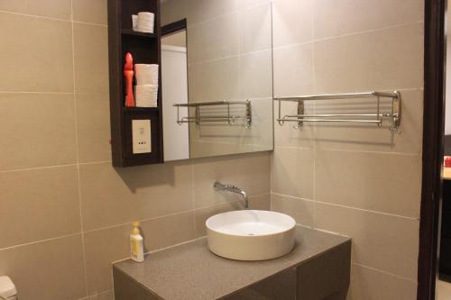 a bathroom with a sink and a mirror at Adha Studio & Suite Kota Bharu in Kota Bharu