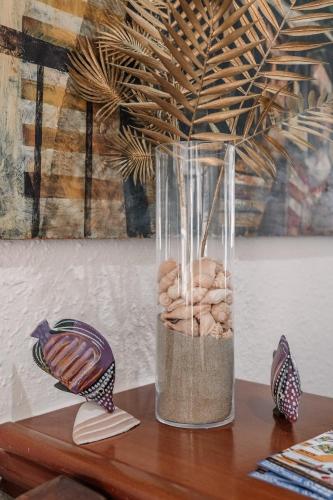 a glass vase filled with rocks on a table at Hotel Apartamentos Londres La Manga in La Manga del Mar Menor
