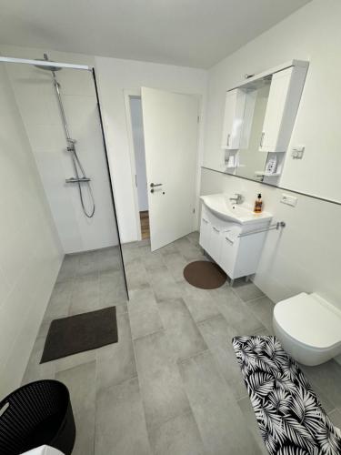 a bathroom with a toilet and a sink at City Villa Bad Dürrheim in Bad Dürrheim
