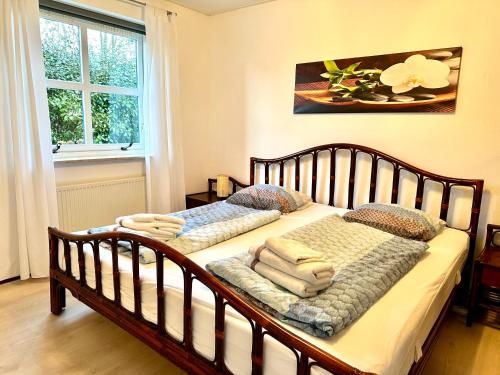 a bedroom with a bed with towels on it at Villa Beach & Sun in Julianadorp