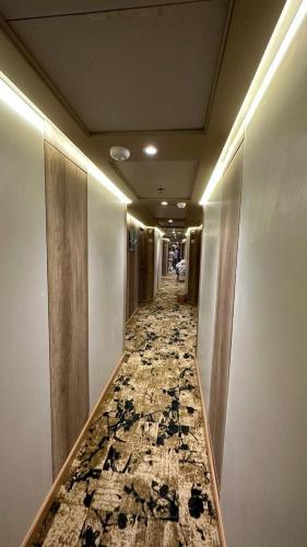 a hallway with a tile floor in a building at M/S Nephtis Nile Cruise in Luxor