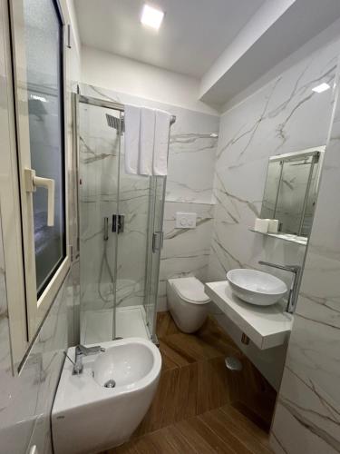 a bathroom with a sink and a toilet and a shower at Hotel Due Pini Conte in Angri