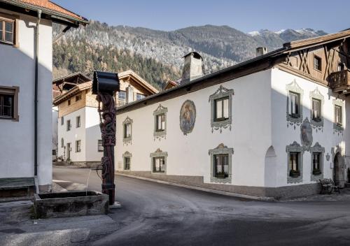 an empty street in a town with a building at Am Dorfbrunnen in Oetz
