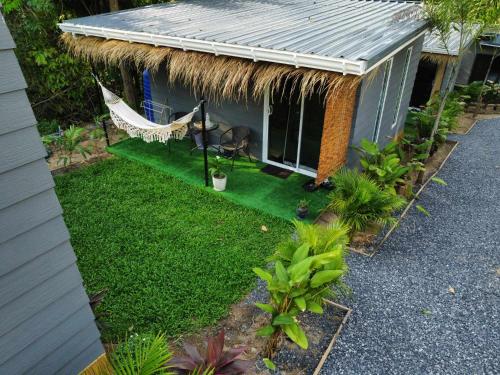 an aerial view of a backyard with a hammock and a house at CyKali Garden Bungalows in Wok Tum