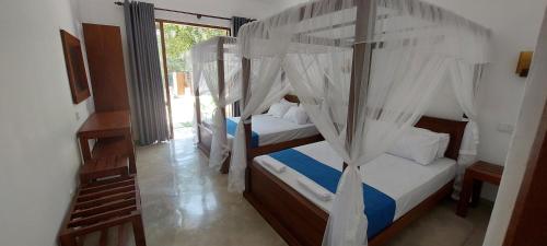 two bunk beds in a room with a window at Green Grove in Matara