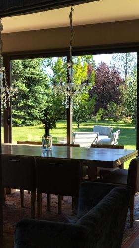 a dining room with a pool table in front of a window at Casa de Huéspedes La Azul in Los Árboles