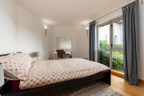 a bedroom with a bed and a large window at Wildings Ardcavan in Wexford