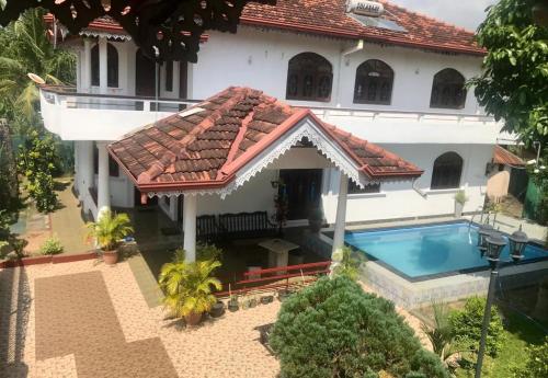 an aerial view of a house with a swimming pool at Kingz and Queenz - Negombo in Negombo