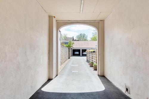 an open hallway with an archway in a house at Maison Bruges in Bruges