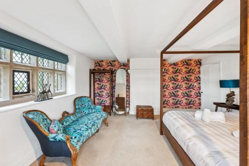 a bedroom with a bed and two chairs at Old Hall Middle - Mayfield in Ashbourne