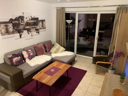 a living room with a couch and a coffee table at Almlodge Flachau in Flachau