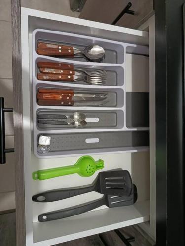 a refrigerator filled with lots of knives and utensils at Departamento en CanCun. in Cancún