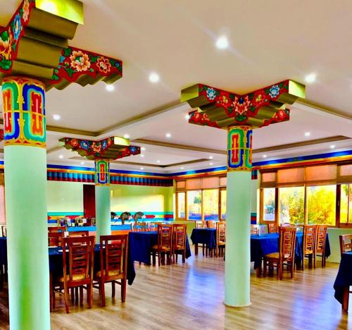 a restaurant with tables and chairs in a room at Niran Boutique Hotel in Leh