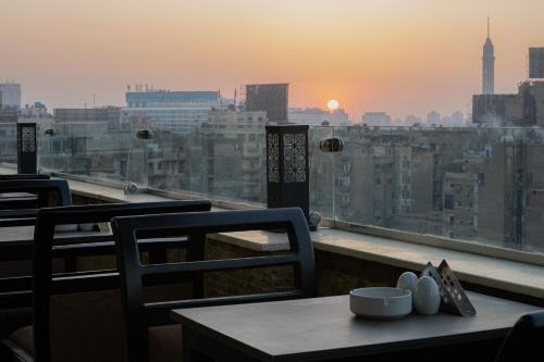 a table and chairs with a view of a city at Holy Sheet Plus in Cairo