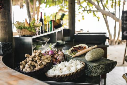a buffet with baskets of food on a table at Atmosphere Kanifushi - Premium All Inclusive with Free Transfers in Lhaviyani Atoll