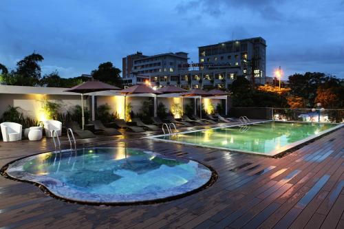 a pool on the rooftop of a hotel at night at Dragon Sea Hotel in Sầm Sơn