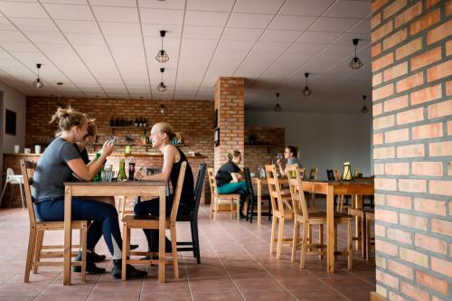 two women sitting at a table in a restaurant at Lascalla pensjonat in Myszewko