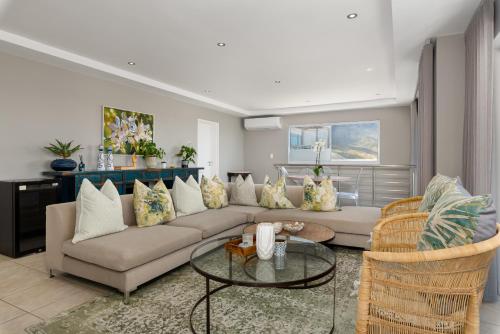 a living room with a couch and a table at 58 Kreef Lane in Cape Town