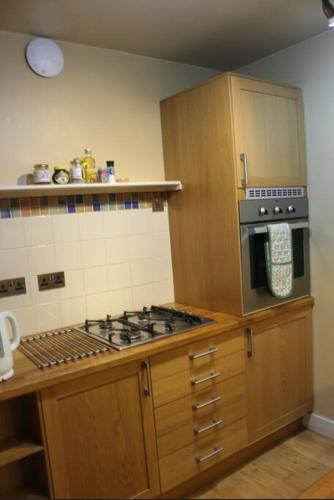 a kitchen with a stove and a stove top oven at Stylish 1 Bedroom Flat in the heart of St Andrew's in Bristol