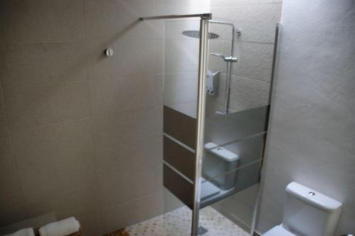 a shower with a glass door in a bathroom at Les Portes in Xàtiva