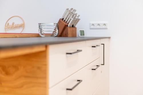 a kitchen with white cabinets and a counter top at Mountain View - by myNests in Gröbming