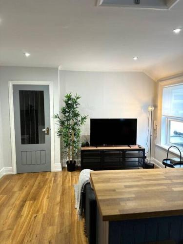 a living room with a flat screen tv at High Wycombe Centre- 2 bed flat in Buckinghamshire