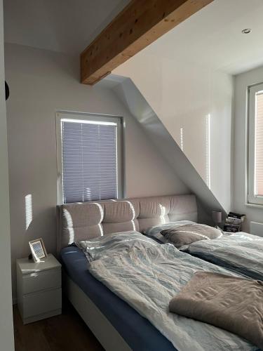 a bed in a bedroom with a stair case at Möbelierte 2 Zimmer Wohnung in Düsseldorf