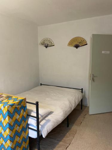 a bed in a room with two mirrors on the wall at Little Temple in Ladywell in London