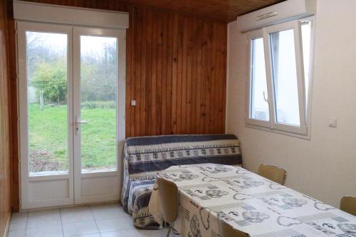 une salle à manger avec une table et une fenêtre dans l'établissement maisonnette, à La Turballe