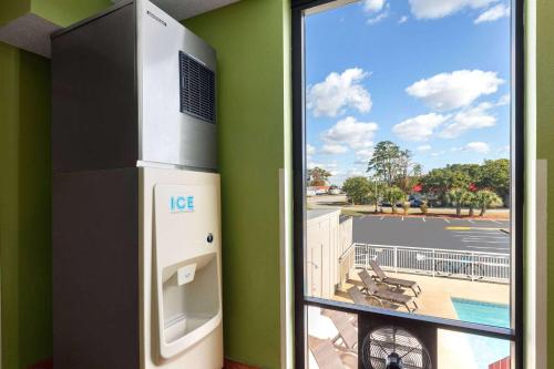 a large window with a view of a parking lot at Super 8 by Wyndham Myrtle Beach/Market Common Area in Myrtle Beach