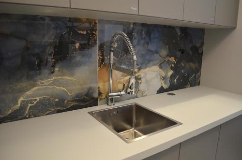 a kitchen with a sink and a counter top at Apartman "INSOMNIA" in Slavonski Brod