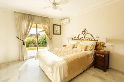 a bedroom with a large bed and a window at Villa Near Beach in Marbella with Heated Pool in Marbella
