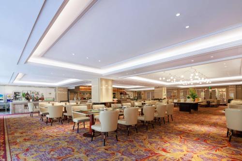 a restaurant with tables and chairs in a room at WYNDHAM Foshan shunde in Shunde