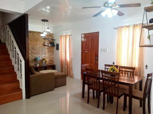 a dining room and living room with a table and chairs at CASITA DE ZACATE in Cagayan de Oro