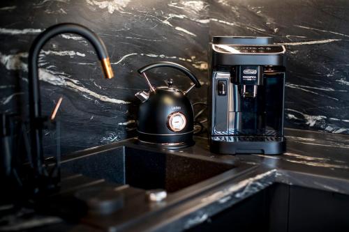 a tea kettle sitting on a counter next to a coffee maker at Loft Point 1 