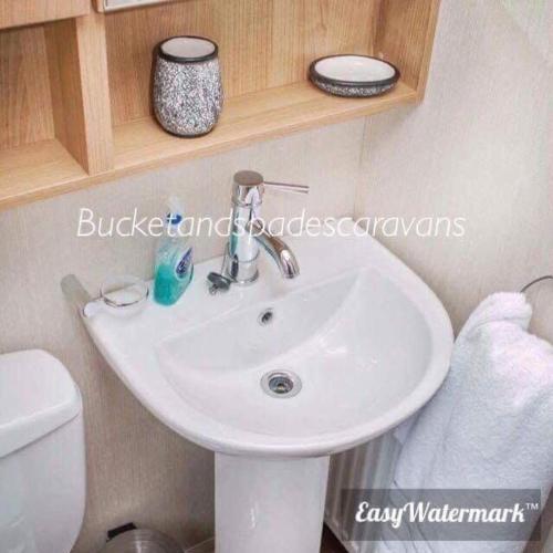 a bathroom with a white sink and a toilet at Blackpool caravans dog friendly in Blackpool