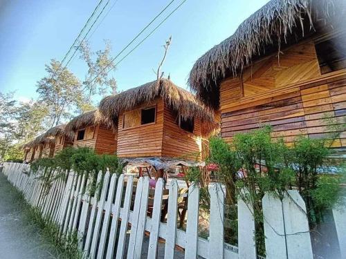 a large wooden building with a straw roof at BALI OF LIWA LAGOON BAR & BEACH RESORT in San Felipe