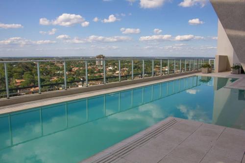 a swimming pool with a view from a building at Esplendor by Wyndham Asuncion in Asuncion
