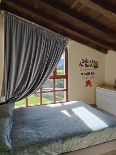 a bedroom with a bed and a window at Eguzkitza in Rentería